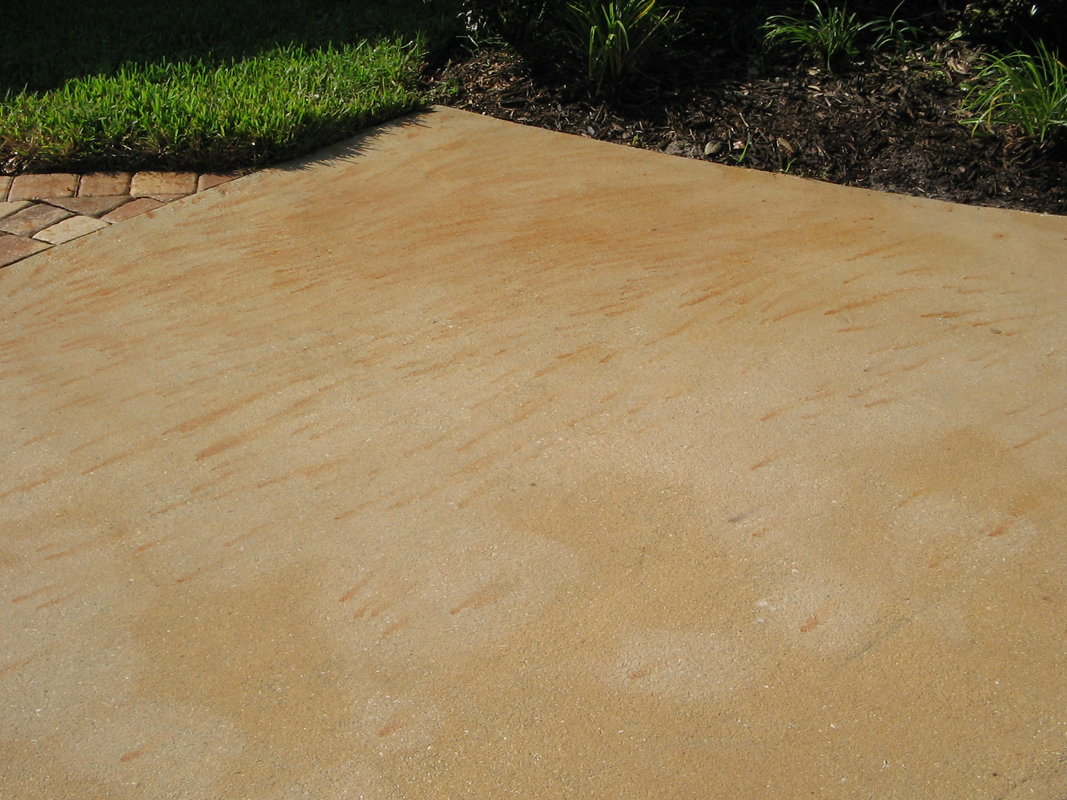 Before fertilizer stain removal on concrete