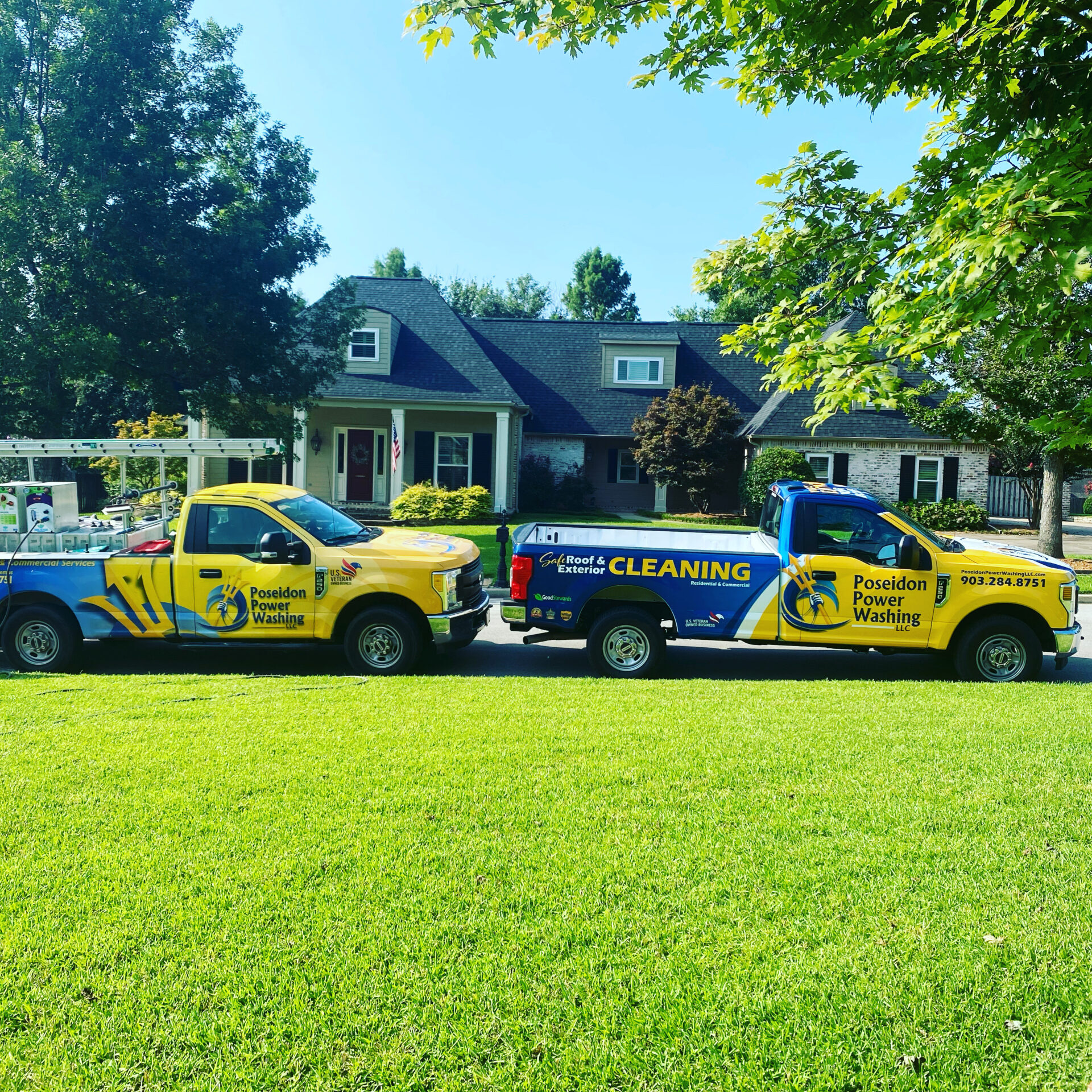 Patriot SoftWash trucks parked outside a home, ready to clean the exterior surfaces